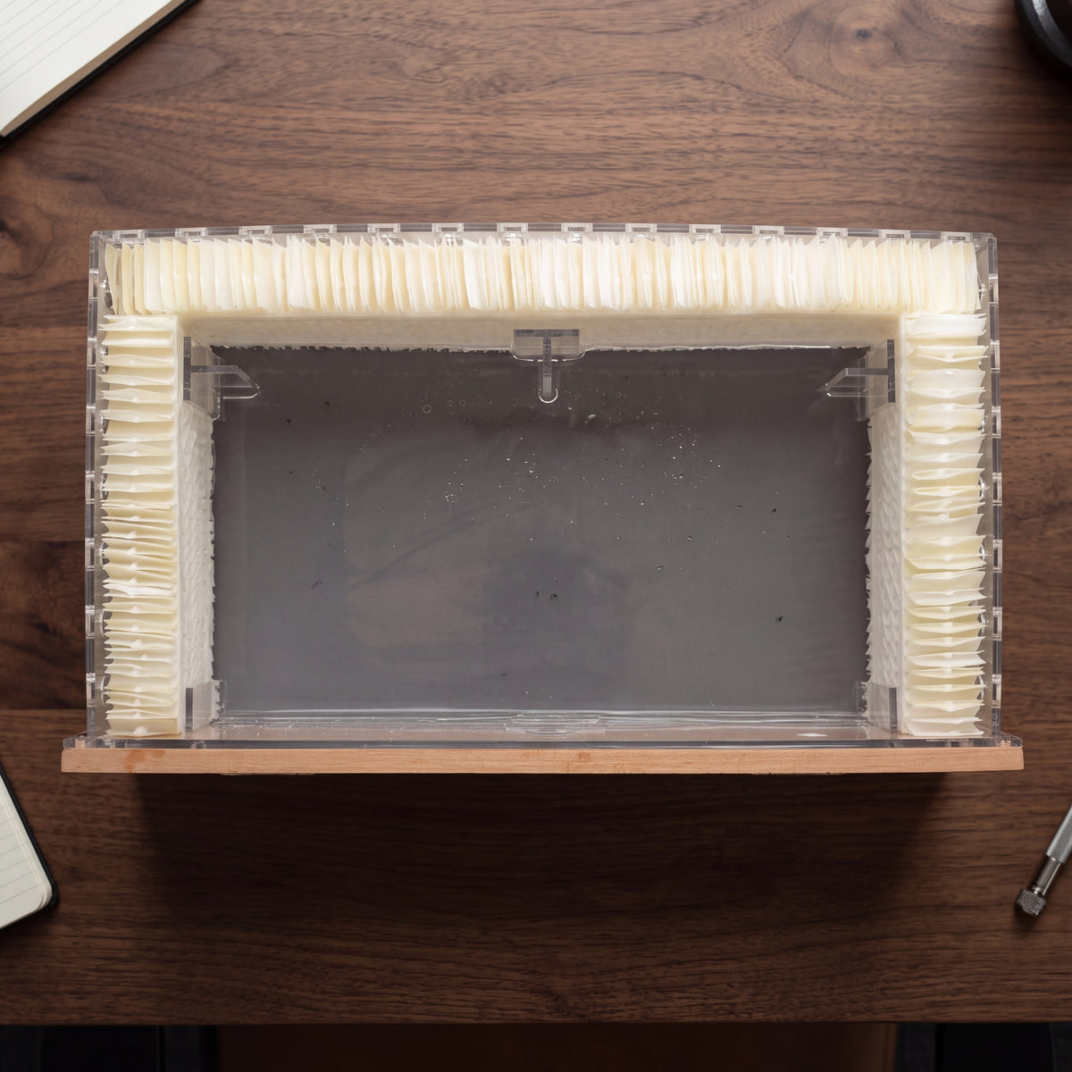 BALANS cigar humidor humidification filter with cream pleated moisture-absorbing membrane on a wooden tabletop